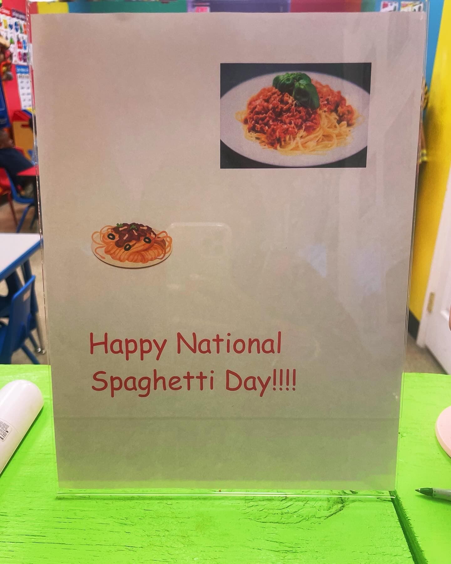 A handmade sign celebrating National Spaghetti Day in the classroom