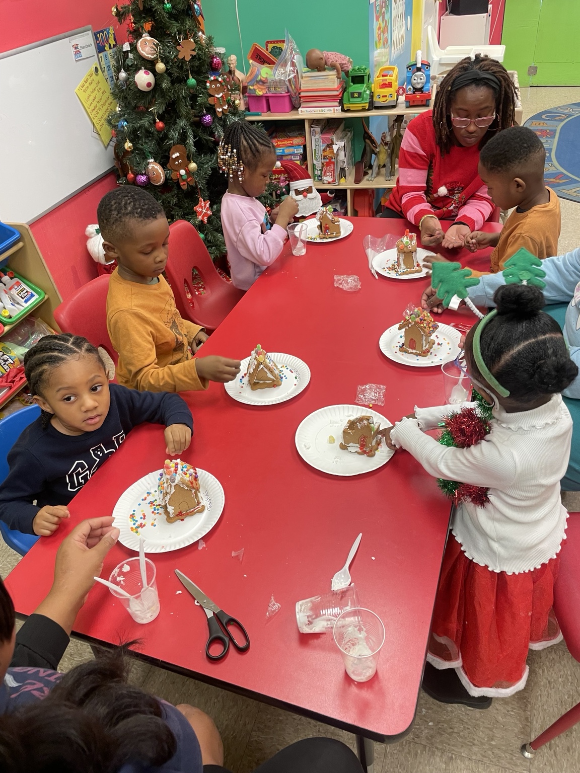 Children decorating gingerbread houses