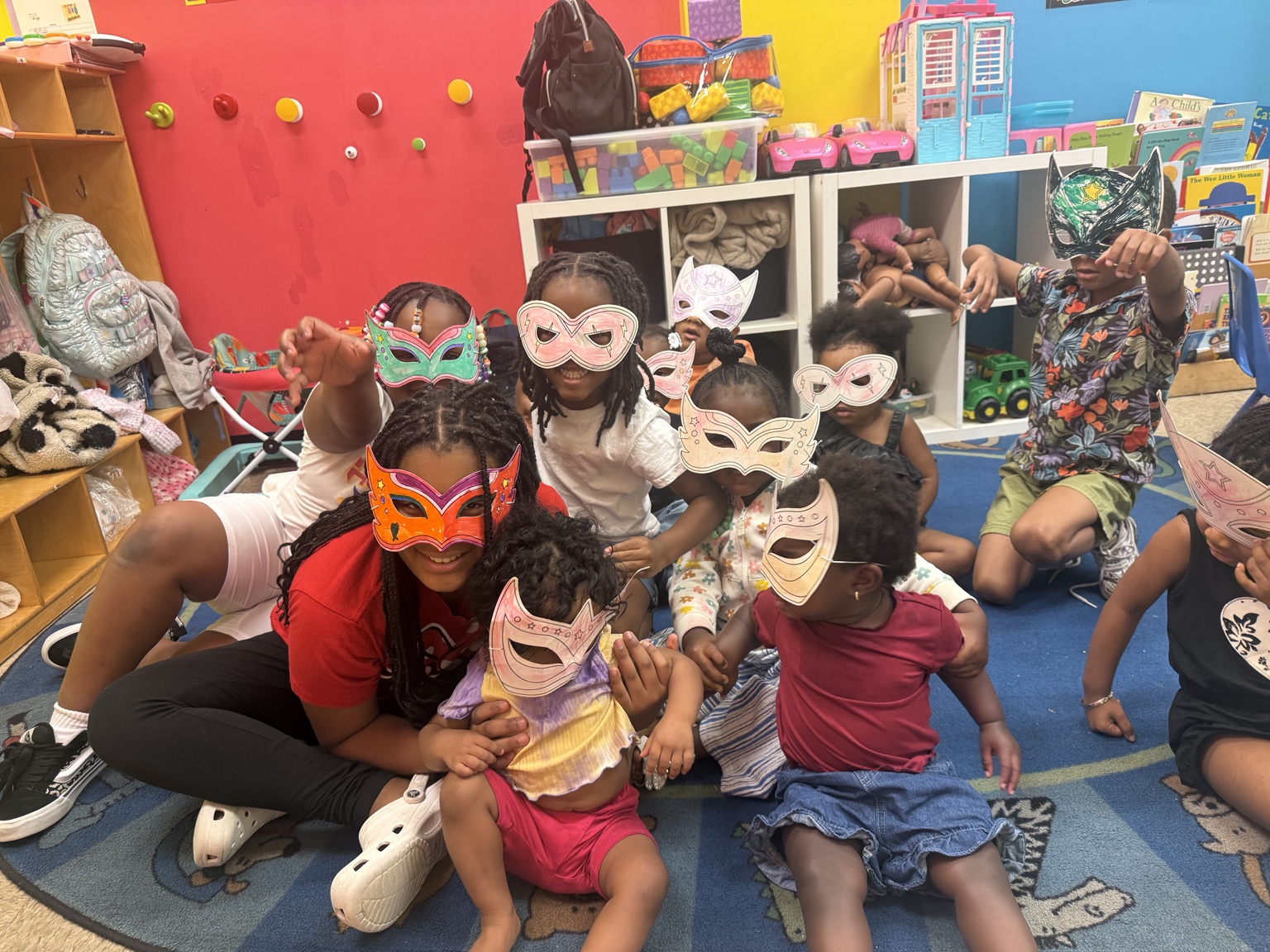 Children posing with handmade masks