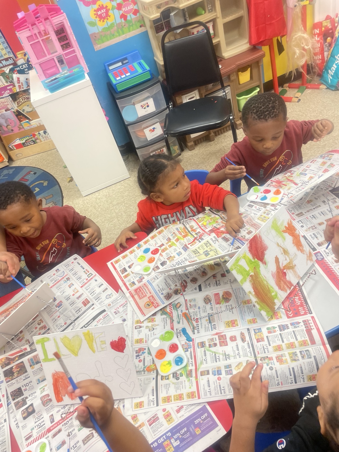 Children painting at a table